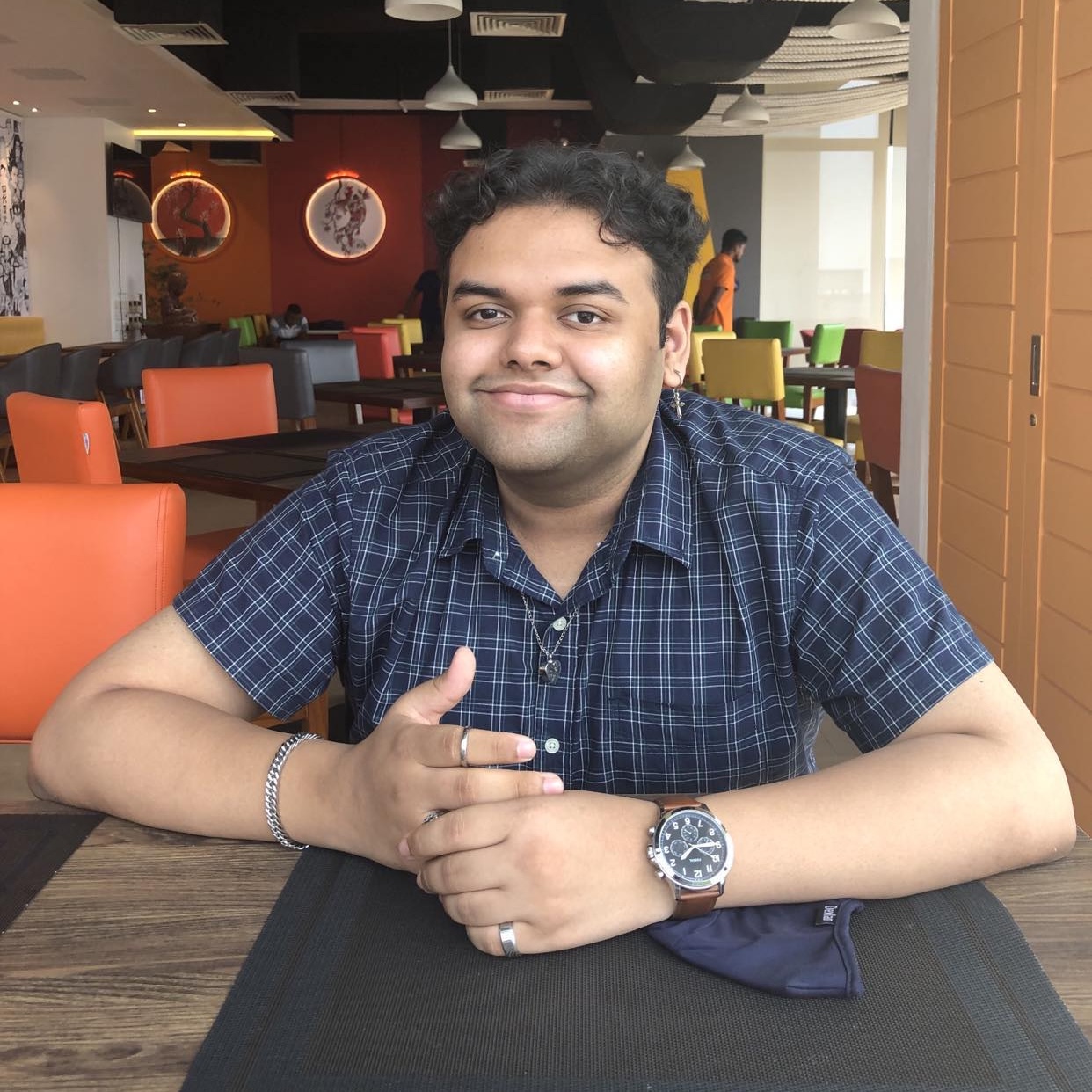 Rajin Khan smiling at a restaurant